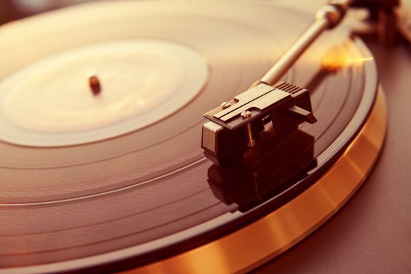 Imagem mostra um toca discos reproduzindo um disco de vinil